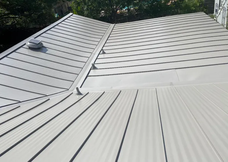 Solar attic fan installed on a metal roof for Roof Ventilation in Tampa